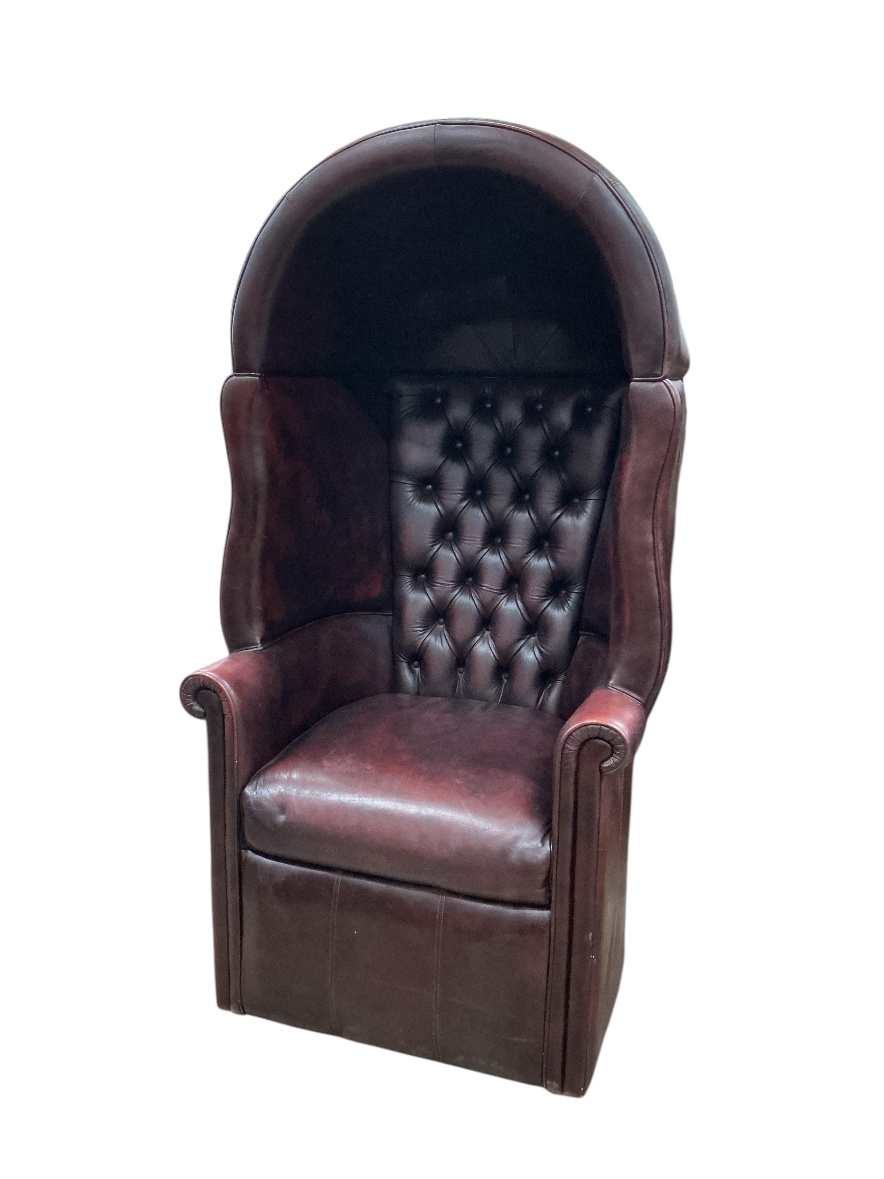 A reproduction buttoned burgundy leather hall porter's chair, width 88cm, depth 64cm, height 176cm